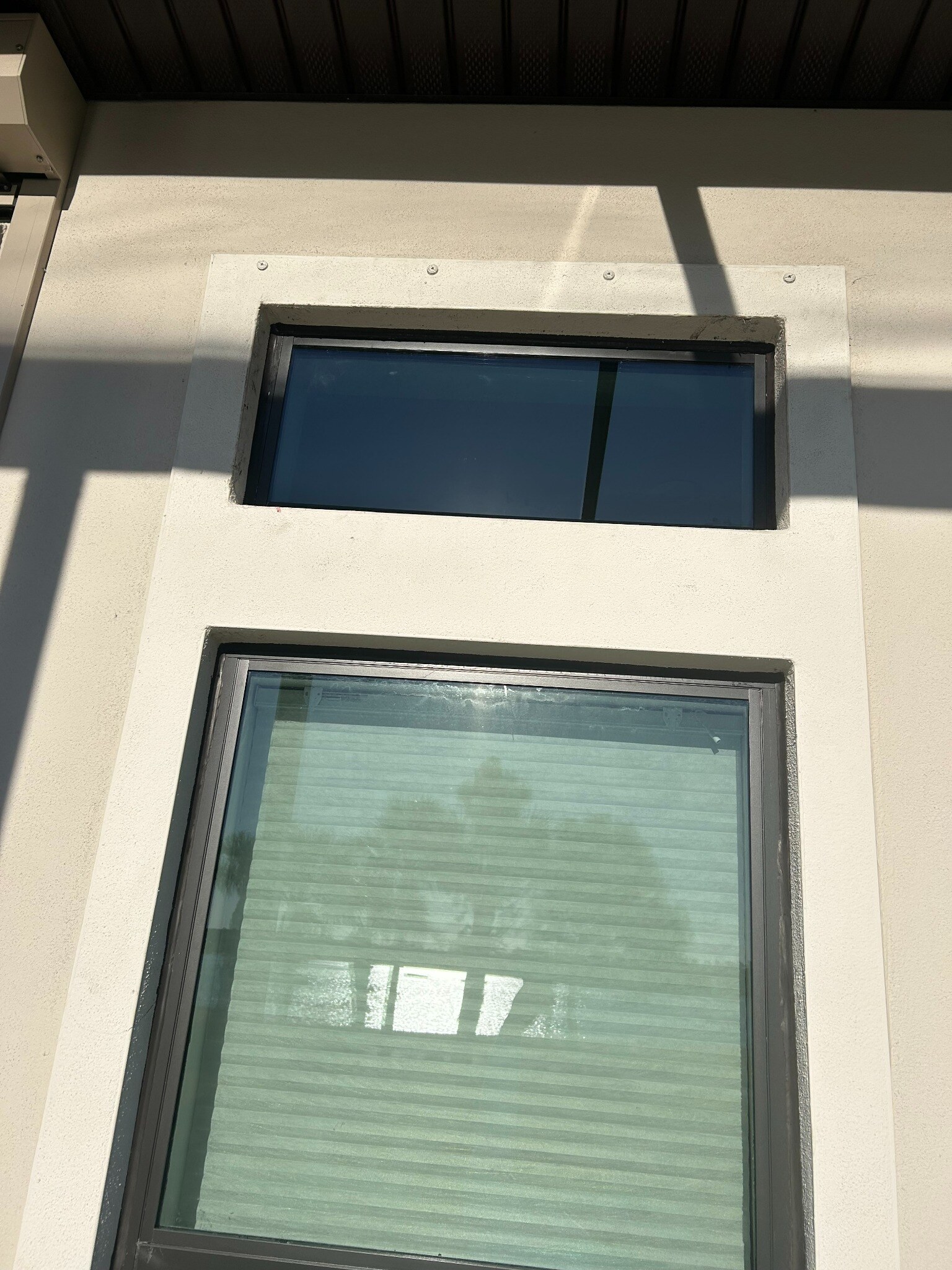 Replacement glass installed in dark aluminum frame