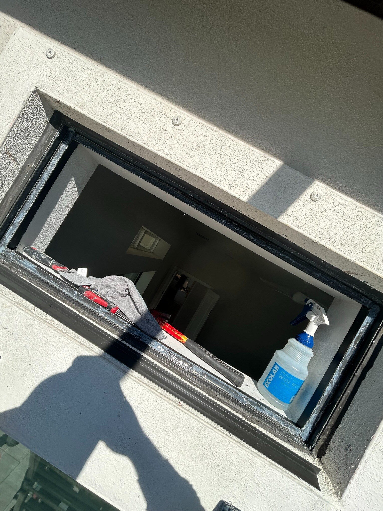 Dark aluminum window frame prepared for replacement glass